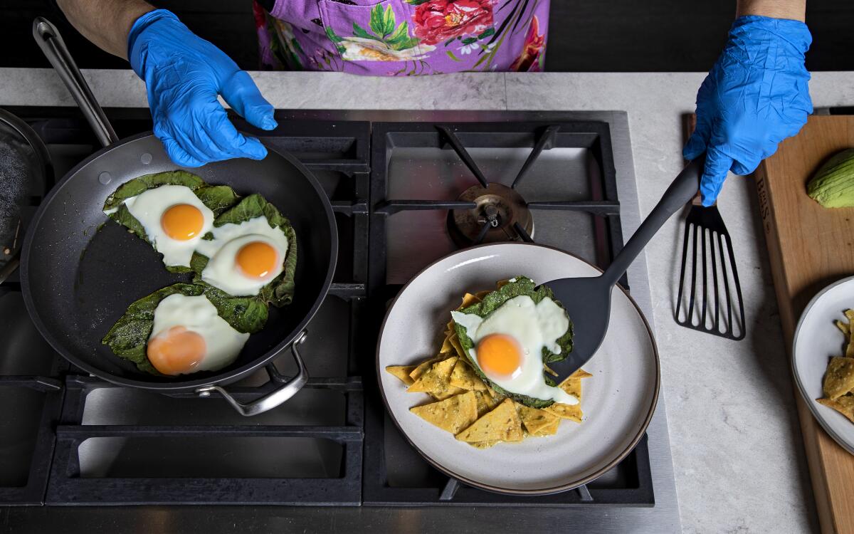 Fried eggs are served onto a plate in the L.A. Times test kitchen.