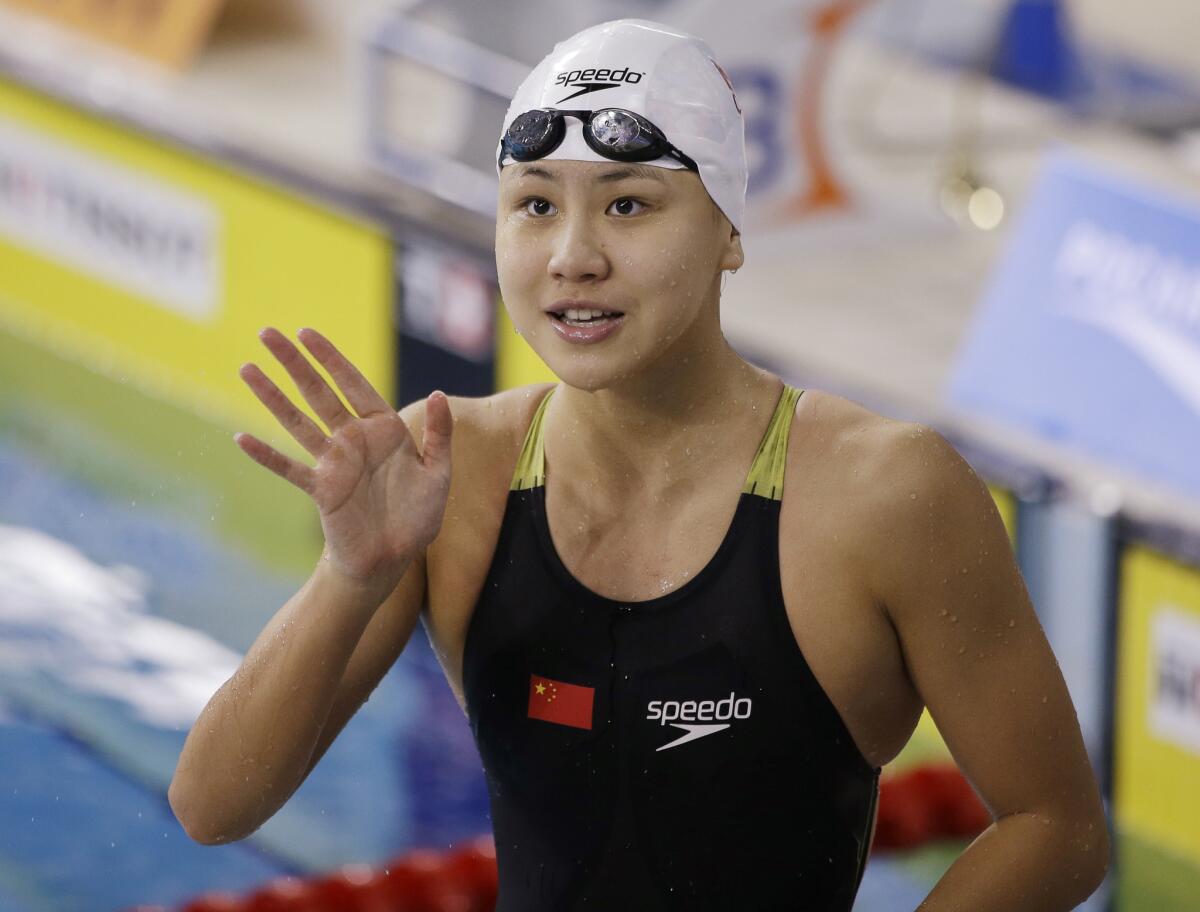 Chinese swimmer Chen Xinyi reacts after winning the women's 50-meter freestyle final at the Asian Games in Incheon, South Korea, on Sept. 26, 2014.
