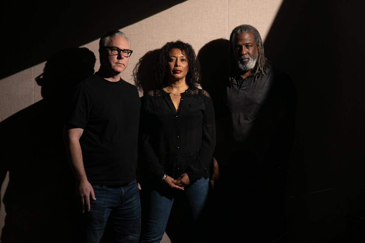 Three audiobook narrators pose standing in shadow against a plain background.