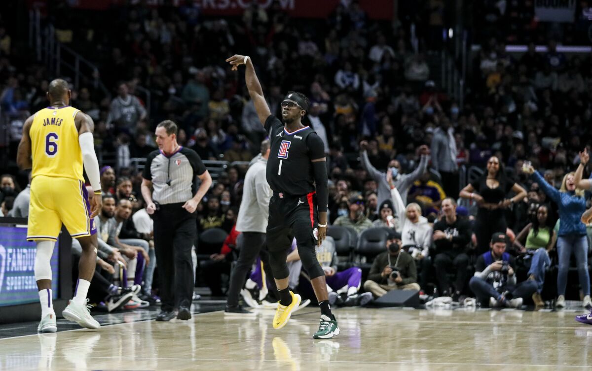 Clippers guard Reggie Jackson celebrates after making a shot during the second half against the Lakers.
