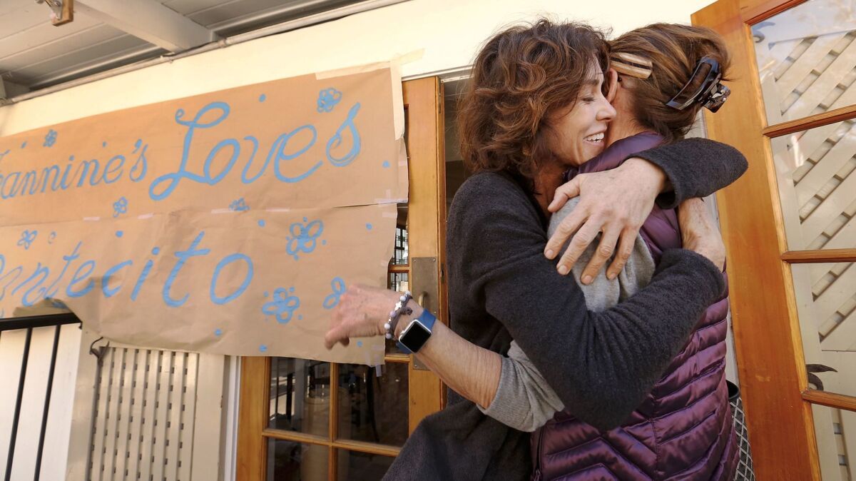 Alison Hardey, left, owner of Jeannine's Bakery on Coast Village Road in Montecito, hugs Nancy Read.