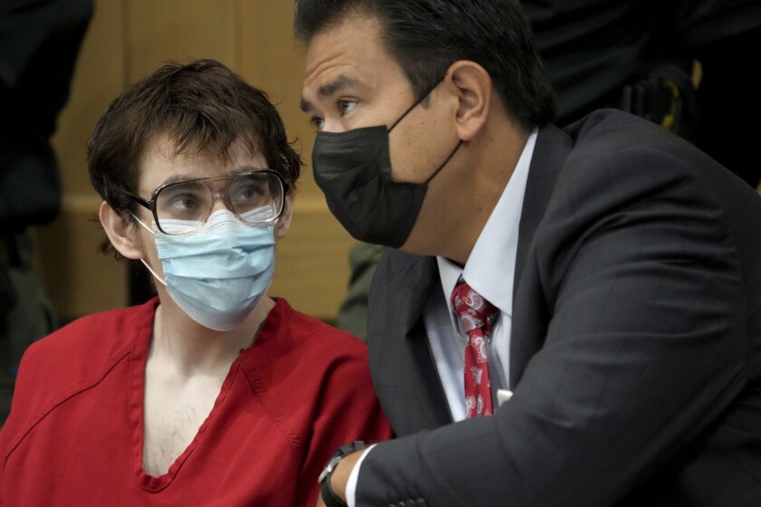 Marjory Stoneman Douglas High School shooter Nikolas Cruz is shown with defense attorney David Wheeler during a hearing at the Broward County Courthouse in Fort Lauderdale, Fla. on Monday, Nov. 15, 2021. Attorneys for Cruz told a judge Monday that detectives made false statements to get the search warrants allowing them to seize evidence from his cellphone and bedroom, including an argument over whether burgundy and maroon are the same color. (Amy Beth Bennett/South Florida Sun Sentinel via AP, Pool)