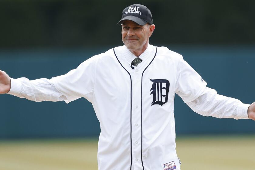 Kirk Gibson reacts after throwing a ceremonial pitch before an opening day baseball game between the New York Yankees and Detroit Tigers, Friday, April 8, 2016, in Detroit. (AP Photo/Paul Sancya)