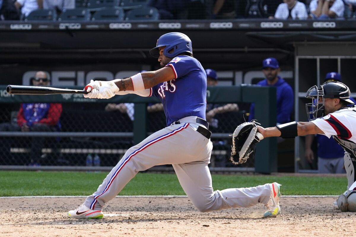 Texas Rangers' Ezequiel Duran hits a three-run home run during the 11th inning of a baseball game against the Chicago White Sox in Chicago, Sunday, June 12, 2022. The Rangers won 8-6. (AP Photo/Nam Y. Huh)