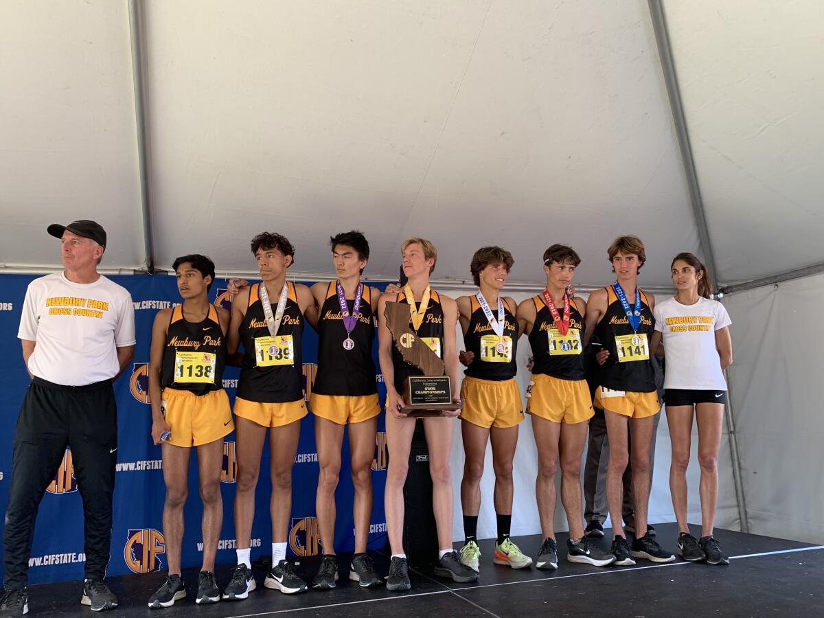 Newbury Park team members celebrate a state cross country championship.