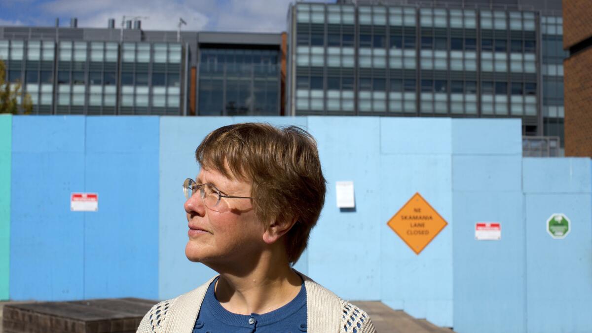 Kathy Bentson stands near the construction site of the University of Washington's controversial $124-million animal research and care facility.