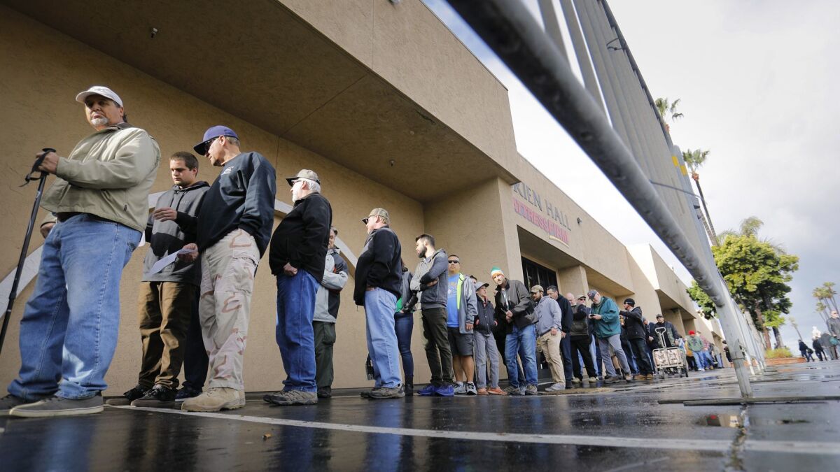 Crossroads of the West Gun Show customers wait in line for the show to open at the Del Mar Fairgrounds on March 17, 2018.