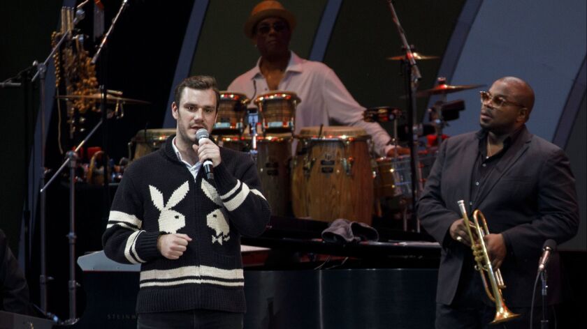 At the Playboy Jazz Festival, during a tribute to his late father Hugh Hefner, Cooper Hefner speaks about his dad, backed by the Miles Electric Band at the Hollywood Bowl on Saturday.