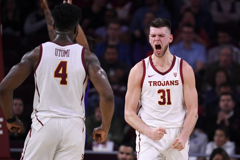 Southern California forward Nick Rakocevic, right, celebrates with guard Daniel Utomi after scoring and drawing a foul during the second half of an NCAA college basketball game against Washington Thursday, Feb. 13, 2020, in Los Angeles. (AP Photo/Mark J. Terrill)