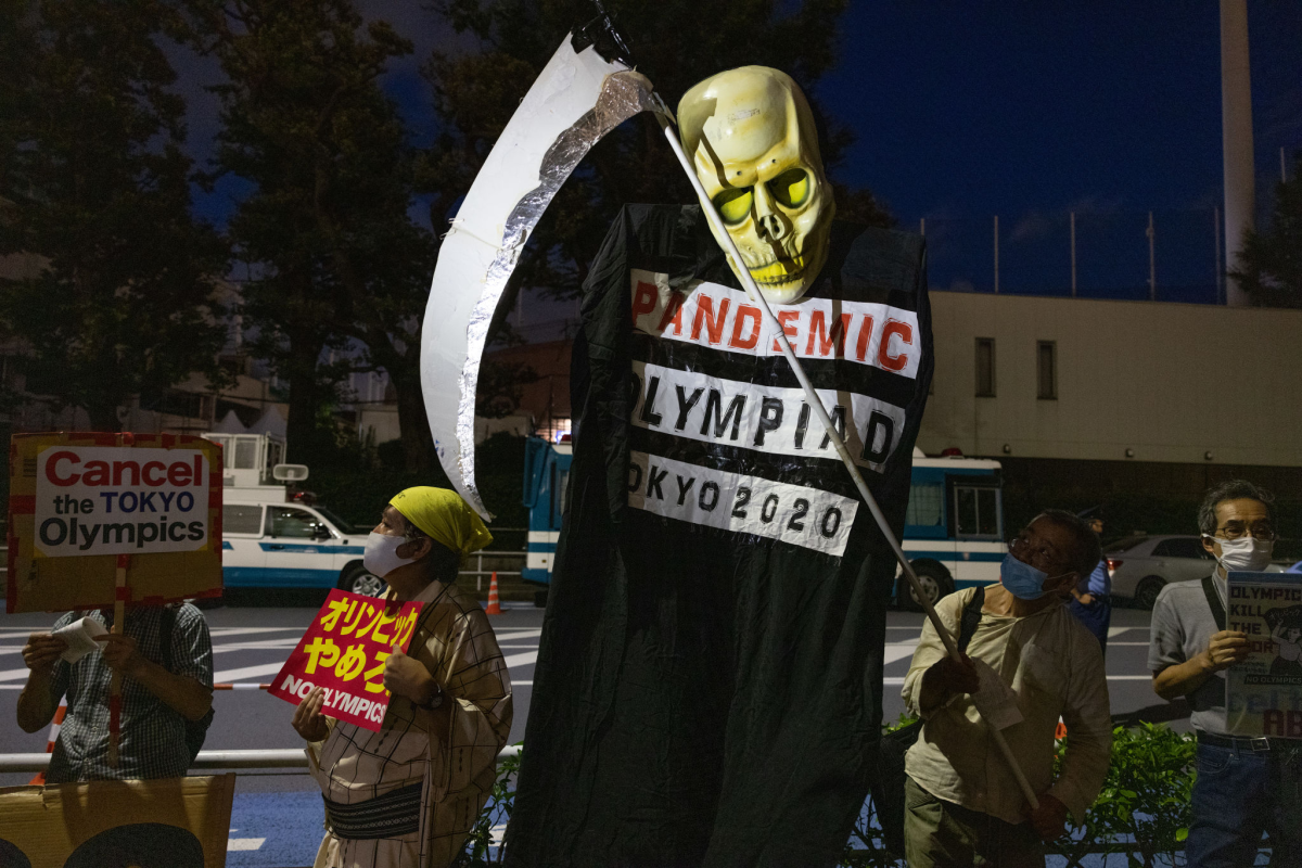Protesters demonstrate near Olympic Stadium in Tokyo on Thursday.