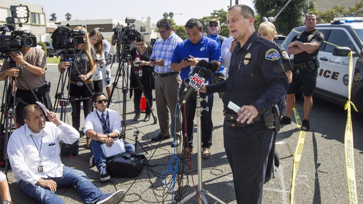 Huntington Beach Police Chief Robert Handy takes questions from reporters about Thursday's shooting involving two police officers along Delaware Street.