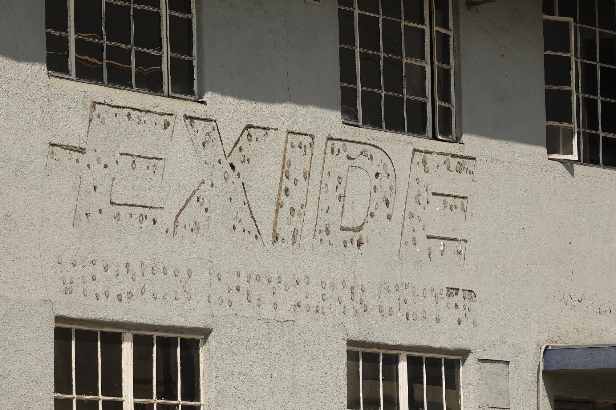 The faded company name is on the exterior of the Exide battery recycling plant in Vernon.