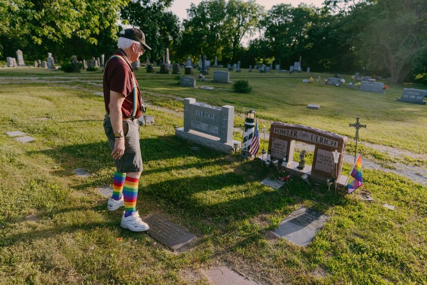 BUNCETON, MO - JUNE 17 2022 Gene Ulrich looks at his late husband, Larry Fowler's grave site. Gene visits the site every day, his sister, her partner, and his parents are also buried here. (Chase Castor / For the Los Angeles Times)