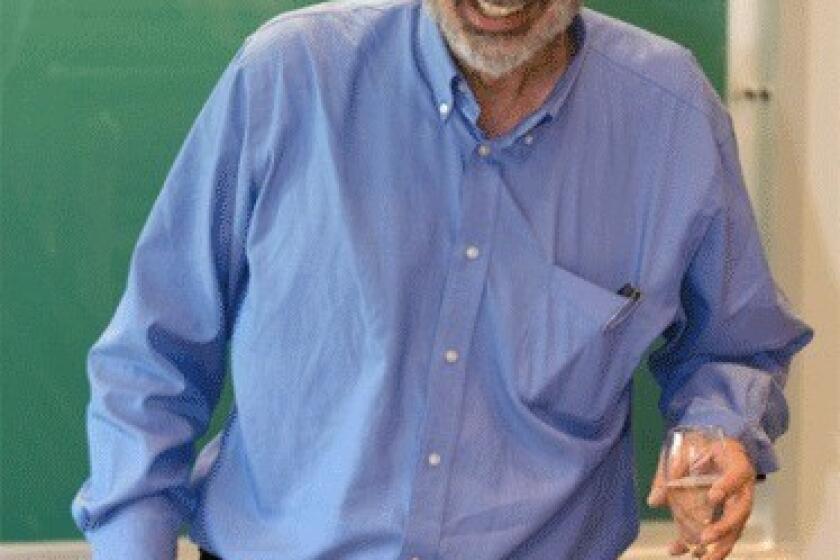 Alvin Roth, a Harvard Business School professor who is currently a visiting professor at Stanford University, reacts during an economics class after receiving a toast from students for being awarded a Nobel Memorial Prize in Economic Sciences.