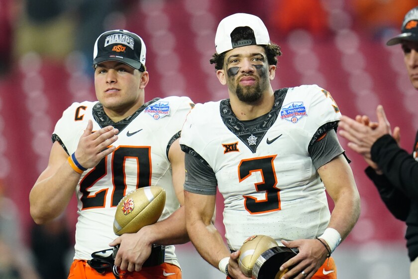 Oklahoma State linebacker Malcolm Rodriguez and quarterback Spencer Sanders celebrate.