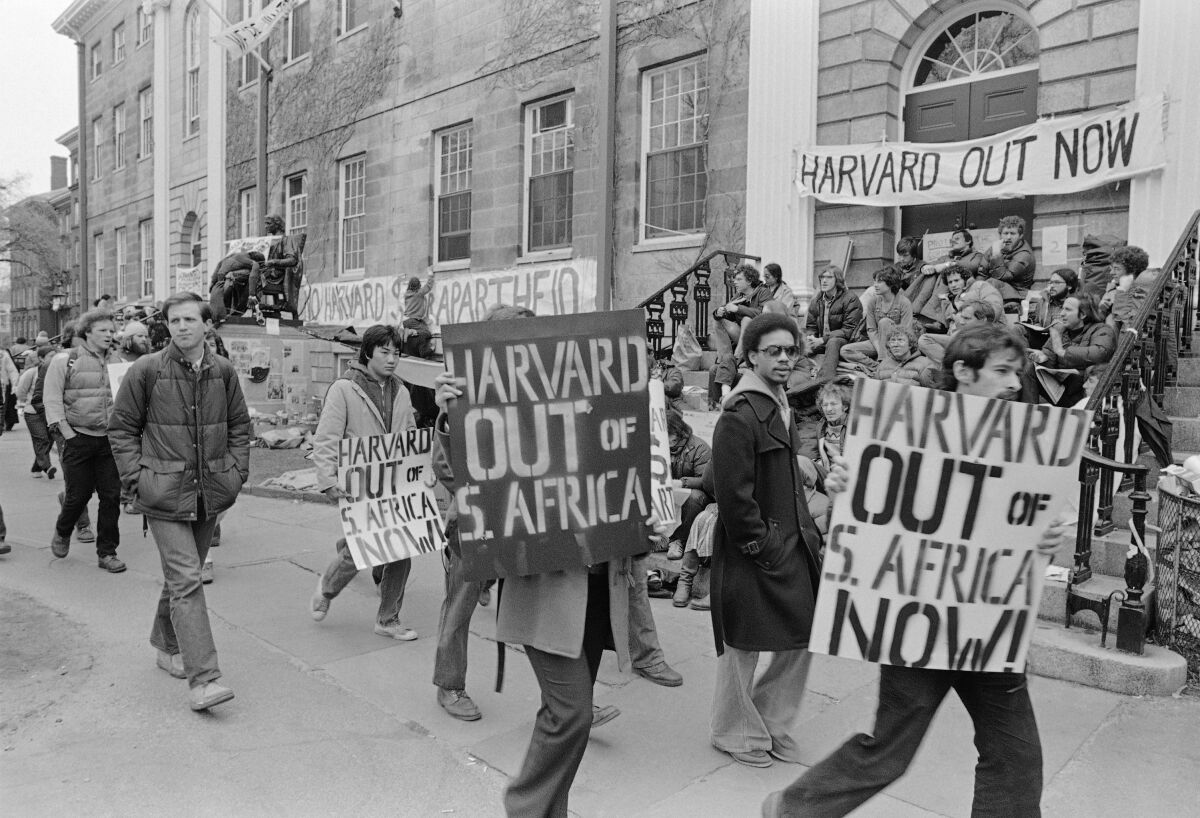 A black-and-white photo of people at an anti-apartheid protest at Harvard in 1978.