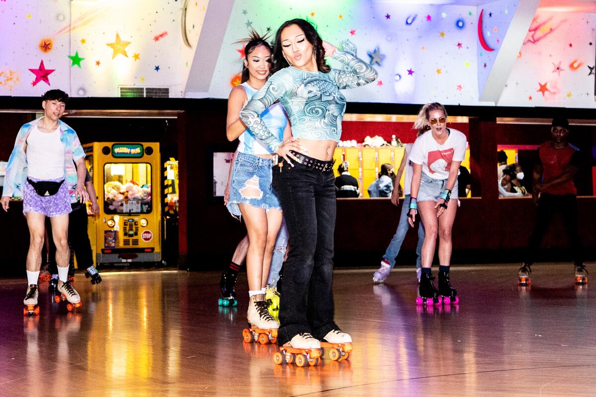 Roller skaters strike poses during Rainbow Skate Night at Moonlight Rollerway.