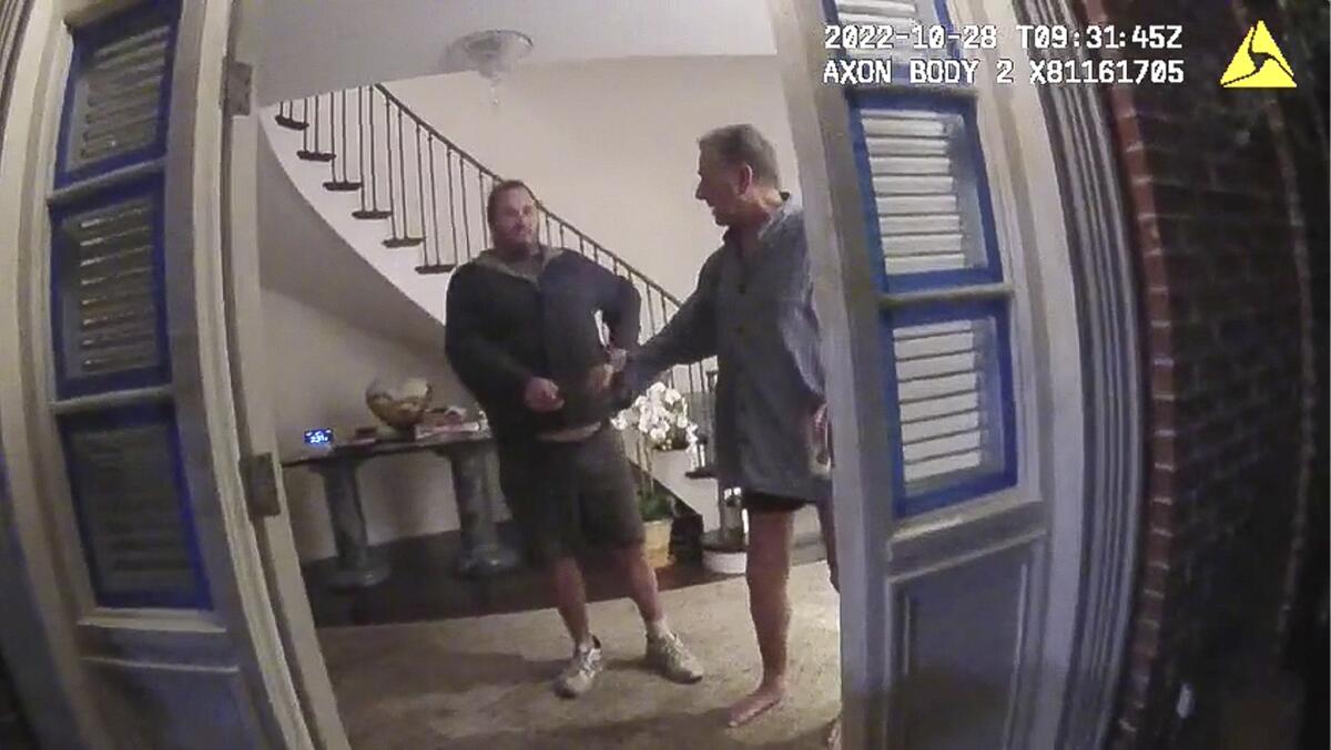 Paul Pelosi and an intruder in an image from police body-cam footage.