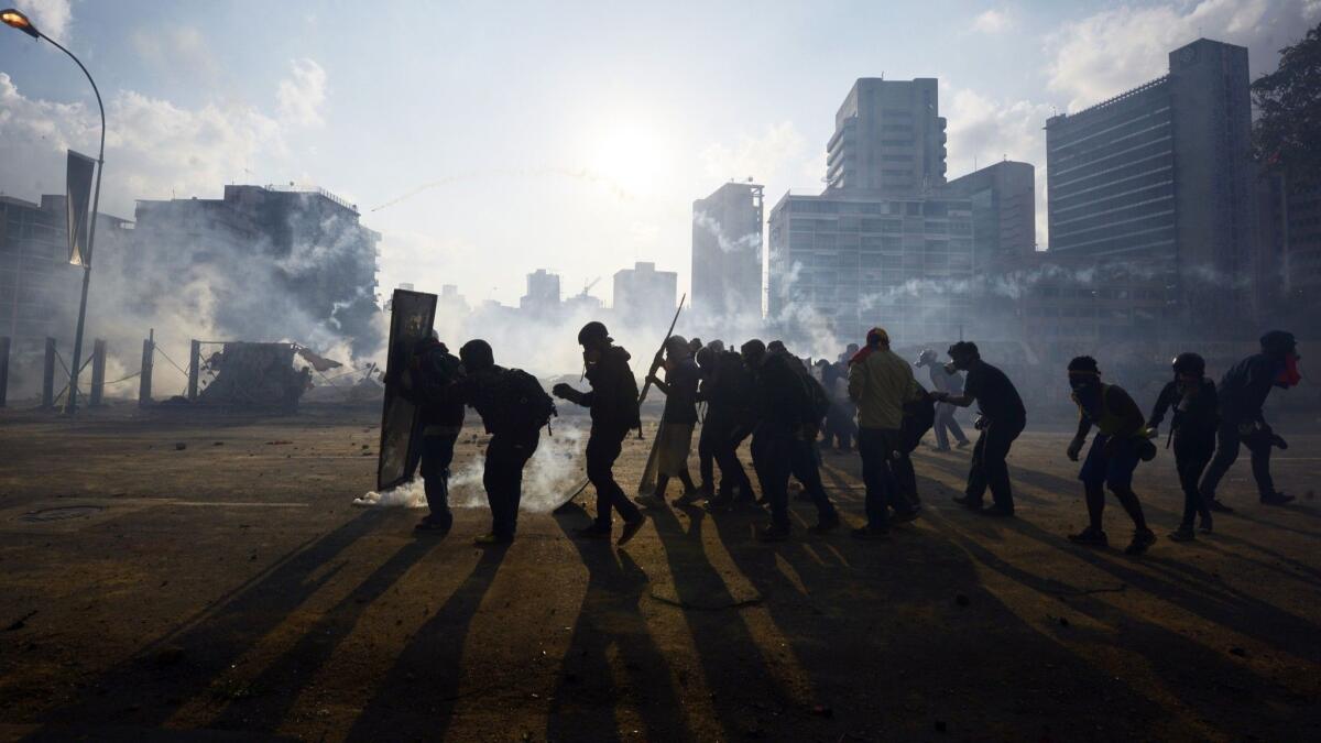 Protesters opposed to Venezuelan President Nicolas Maduro clash with police on the streets of the capital, Caracas.