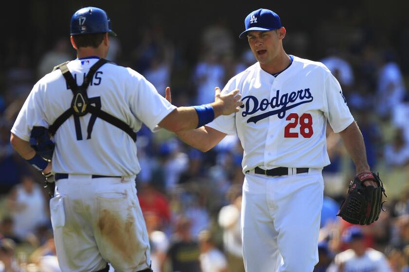 Jamey Wright (28), then a Dodgers closer, shakes hands with catcher A.J. Ellis after a win over St. Louis on June 29, 2014.
