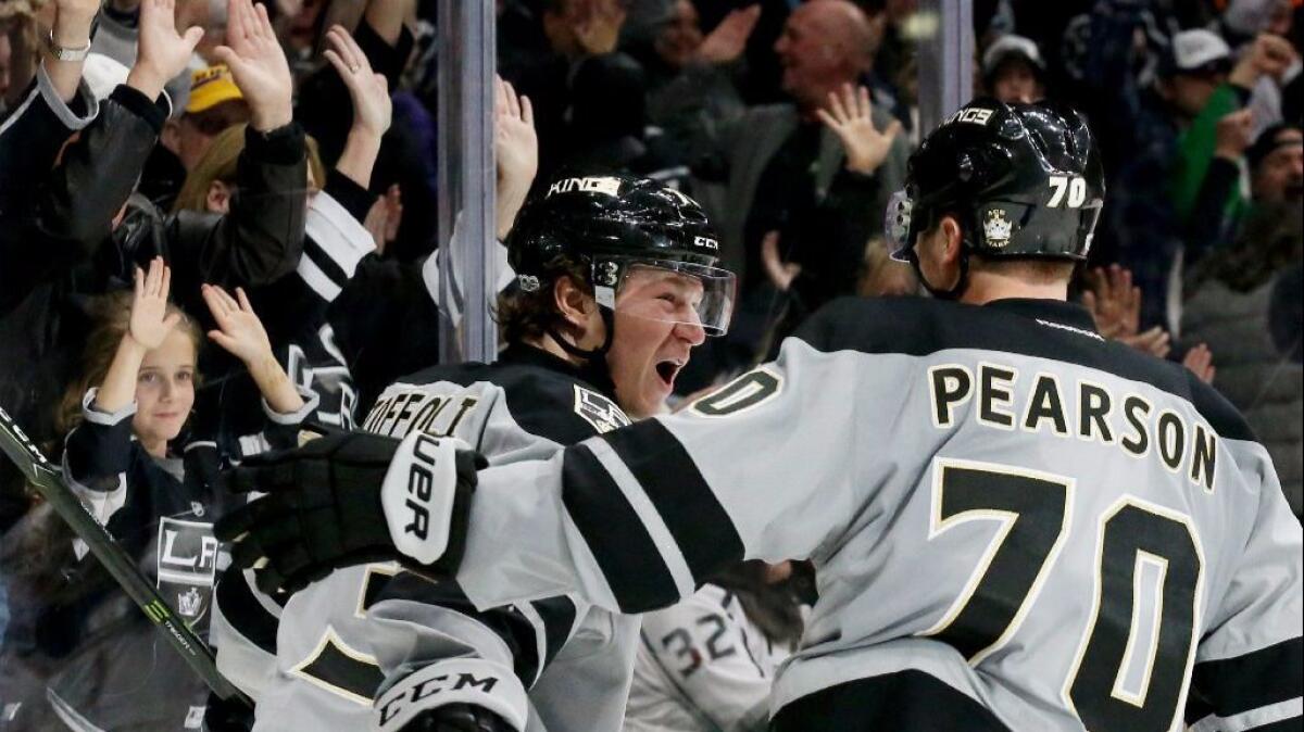Kings center Tyler Toffoli celebrates with teammate Tanner Pearson after scoring a goal against the Ducks during the third period of a game Sunday.