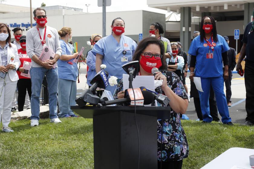 Respiratory therapist Christina Rodriguez, who has worked here for 17 years and has asthma and diabetes, speaks during a press conference outside of Fountain Valley Regional Hospital's emergency room on Thursday. Hospital workers are dissatisfied with the safety protocols being implemented at Fountain Valley Regional Hospital.