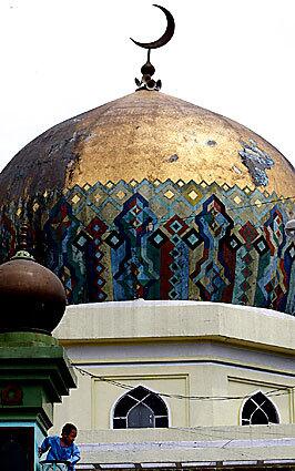 The dome of the Golden Mosque rises above the teeming neighborhood of Quiapo in Manila, where many Philippine Muslims live in poverty. No one has claimed responsibility for a recent spate of bombings, but accusations have predictably been leveled at extremist factions within the Muslim community, which is a minority in the largely Roman Catholic nation.