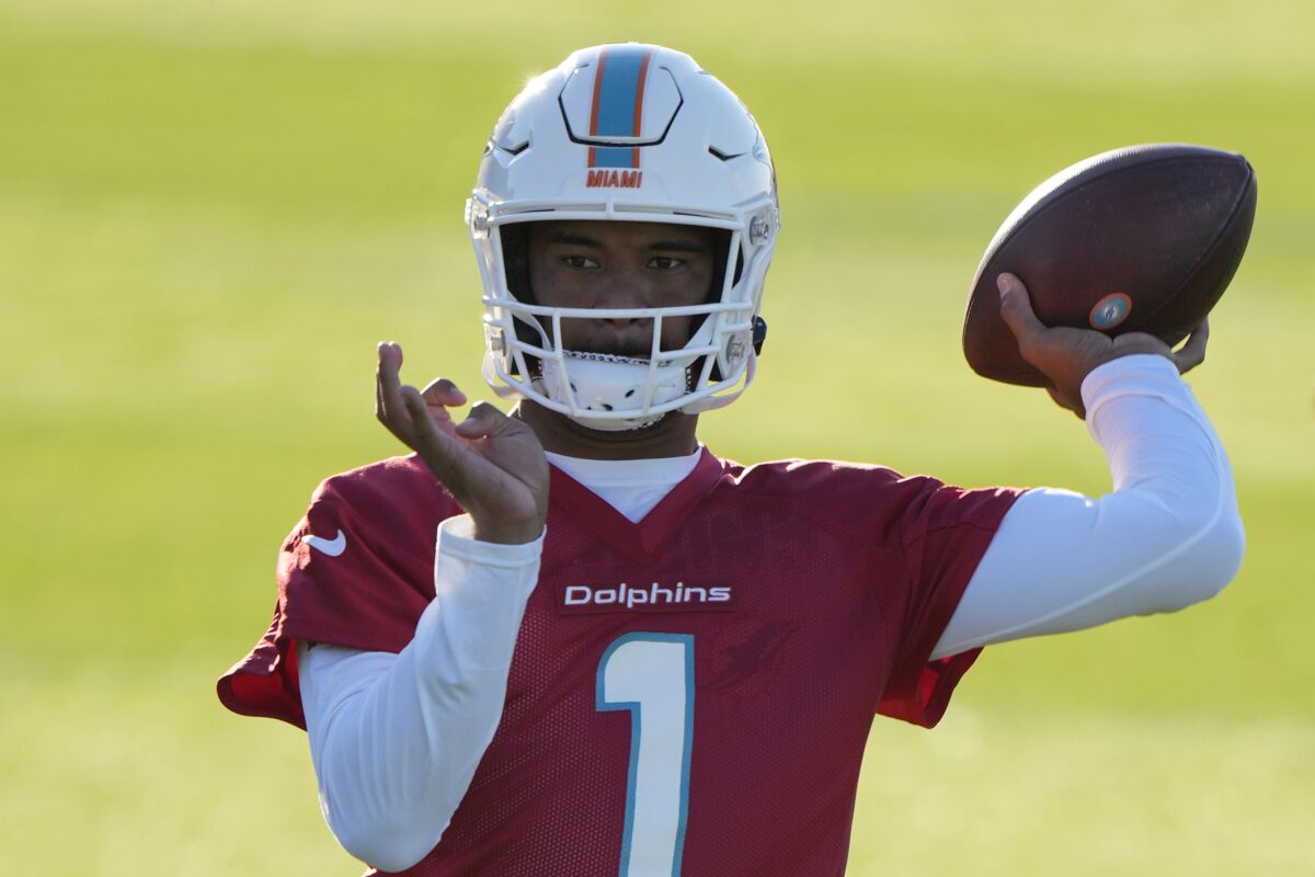 Dolphins quarterback Tua Tagovailoa throws the ball during a practice and media availability by the Miami Dolphins In Ware, England, Friday, Oct. 15, 2021. The Dolphins play the Jaguars in a regular season NFL game on Sunday at Tottenham Hotspurs White Hart Lane stadium in London. (AP Photo/Alastair Grant)