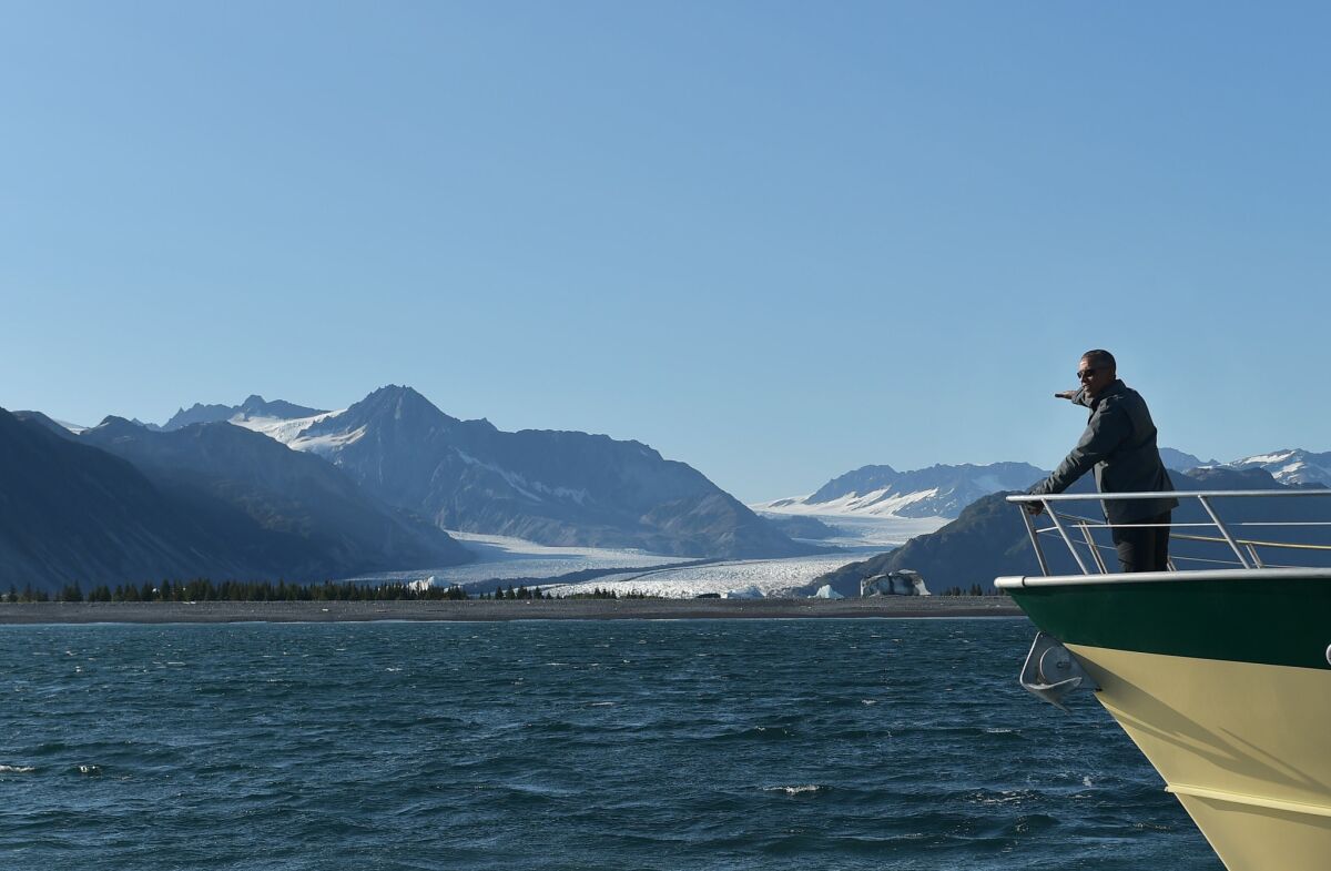 President Obama points to Bear Glacier during a boat tour of Alaska's Kenai Fjords National Park on Sept. 1.