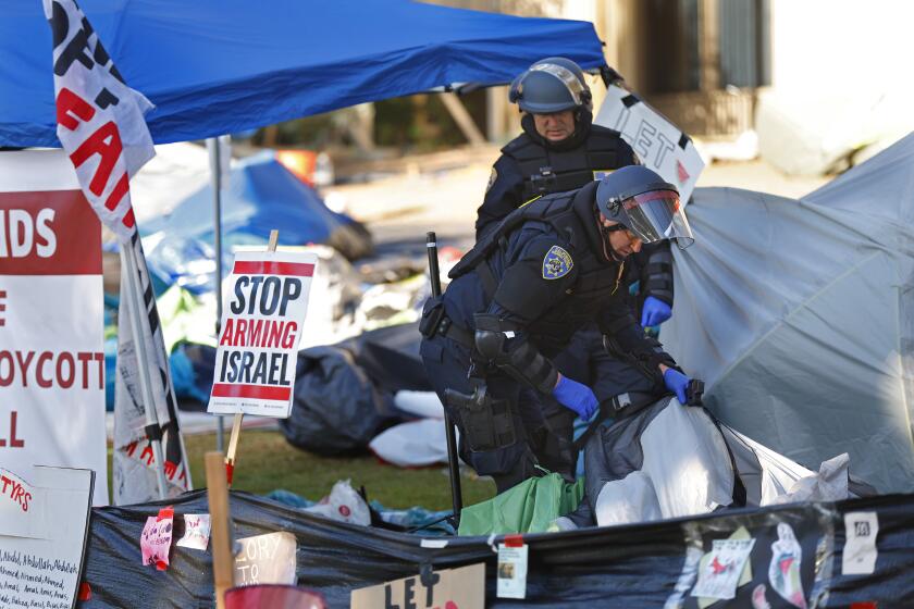San Diego CA - May 6: CHP officers look through a Free Palestine Camp along Library Walk at UC San Diego on Monday, May 6, 2024. Protesters, who have been staged at the university for several days were arrested earlier in the morning. (K.C. Alfred / The San Diego Union-Tribune)