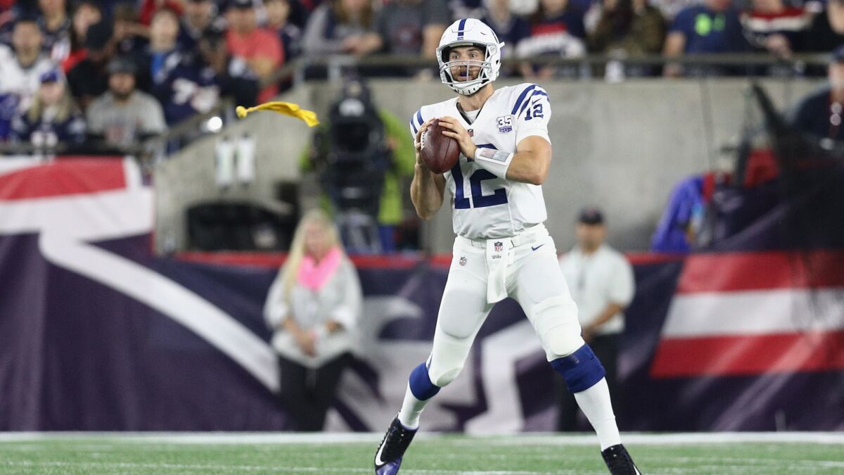A flag is thrown as Colts quarterback Andrew Luck looks to pass against the New England Patriots.