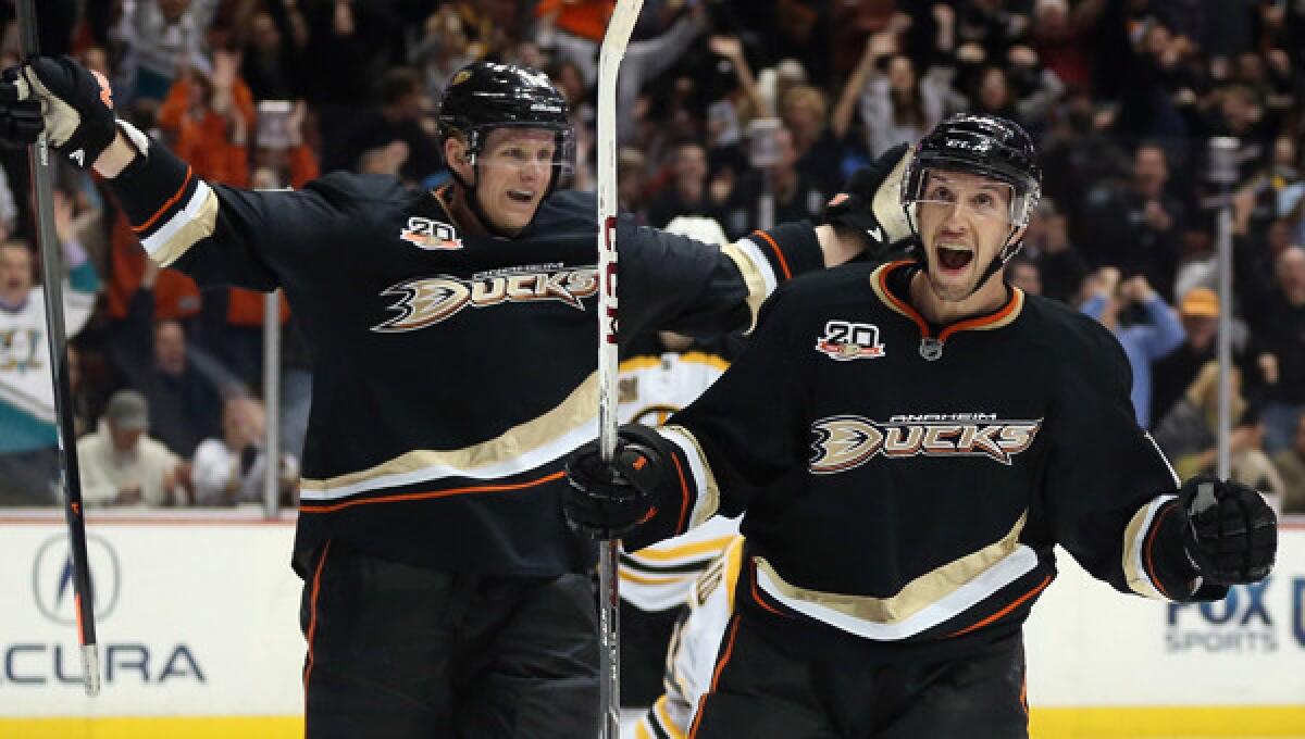 Ducks forward Nick Bonino, right, celebrates with teammate Corey Perry after scoring a third-period goal in a 5-2 win over the Boston Bruins on Tuesday. The high-flying Ducks will look to extend their winning streak to five games with a road win Thursday over the Nashville Predators.