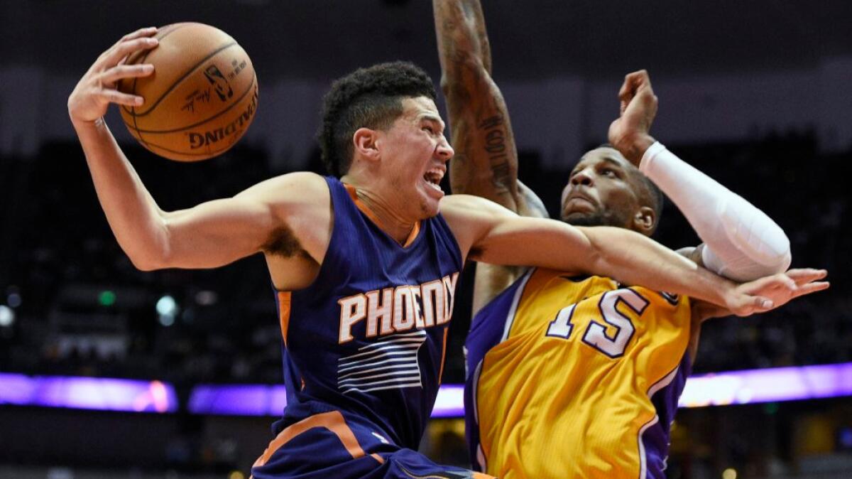 Suns guard Devin Booker drives against Lakers guard Thomas Robinson during a preseason game on Oct. 21.
