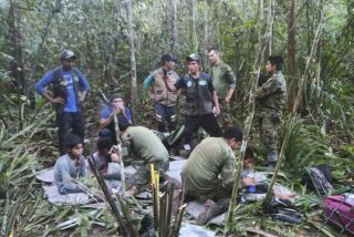 In this photo released by Colombia's Armed Forces Press Office, soldiers and Indigenous men tend to the four Indigenous brothers who were missing after a deadly plane crash, in the Solano jungle, Caqueta state, Colombia, Friday, June 9, 2023. Colombian President Gustavo Petro said Friday that authorities found alive the four children who survived a small plane crash 40 days ago and had been the subject of an intense search in the Amazon jungle that held Colombians on edge. (Colombia's Armed Force Press Office via AP)