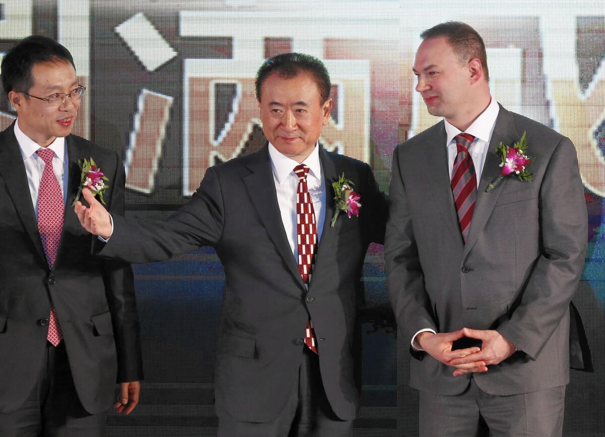 Wang Jianlin, center, chairman of China's Wanda Group, with Thomas Tull, right, CEO of U.S. film company Legendary, after Wanda Group's $3.5-billion acquisition.
