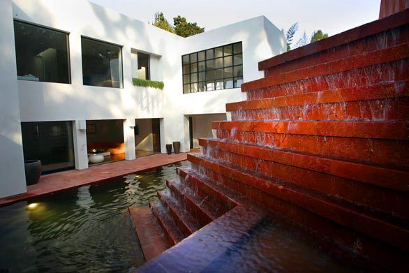 Water cascades down 10 stepped ledges. When anyone wants to use the pool as additional patio space, it can be drained without affecting the operation of the fountain.