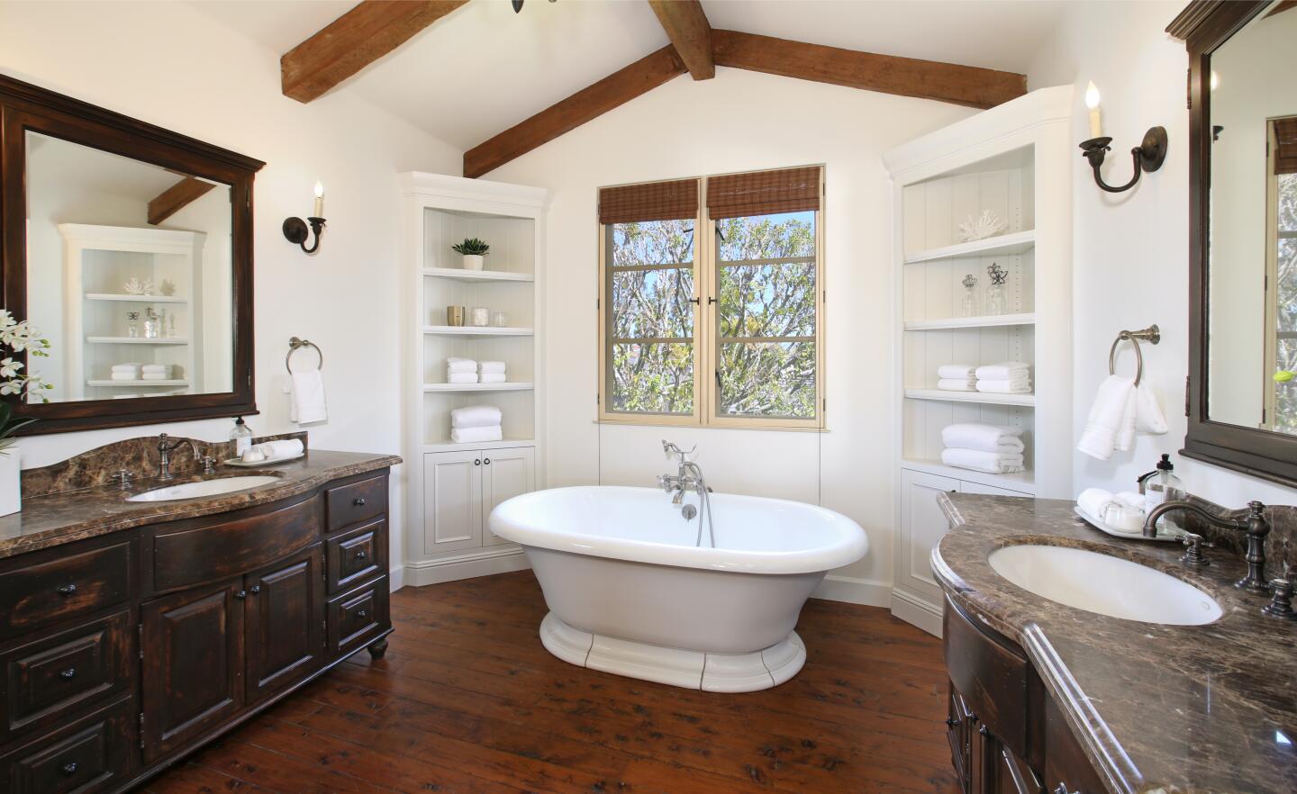 A standing tub, wood beam ceilings and corner built-ins.