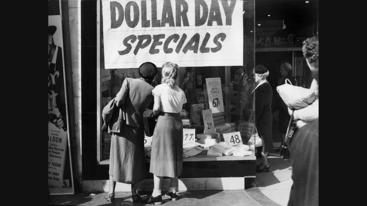 Shoppers view Dollar Day specials in a photo published on Feb. 7, 1953.