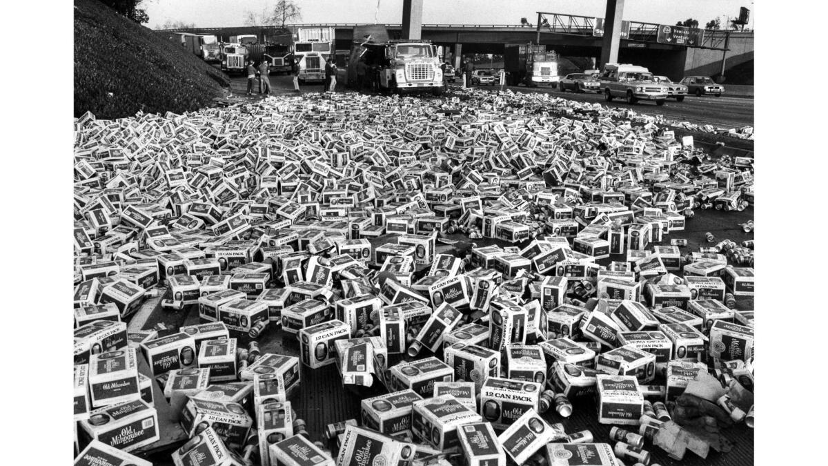 Feb. 12, 1985: Cases of beer clog a transition road between the 101 Freeway and the 5 after a semi-trailer truck overturned.