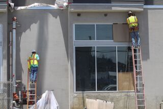 Construction workers work on The Stella, an 85-unit building for homeless veterans currently under construction in the Grantville neighborhood on Tuesday, June 11, 2019 in San Diego, California.