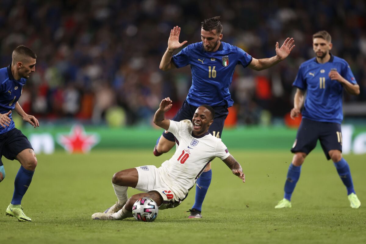 England's Raheem Sterling falls in front of Italy's Bryan Cristante
