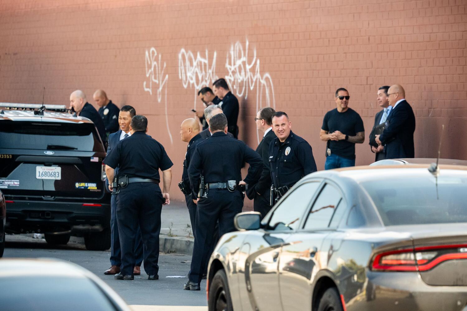 Los Angeles, CA, United States - October 21: Police gather at the scene of where a deputy U.S. marshal working on a federal immigration enforcement task force was wounded during an operation in South Los Angeles on Tuesday, Oct. 21, 2025 in Los Angeles, CA. (Ethan Swope/For The Times)