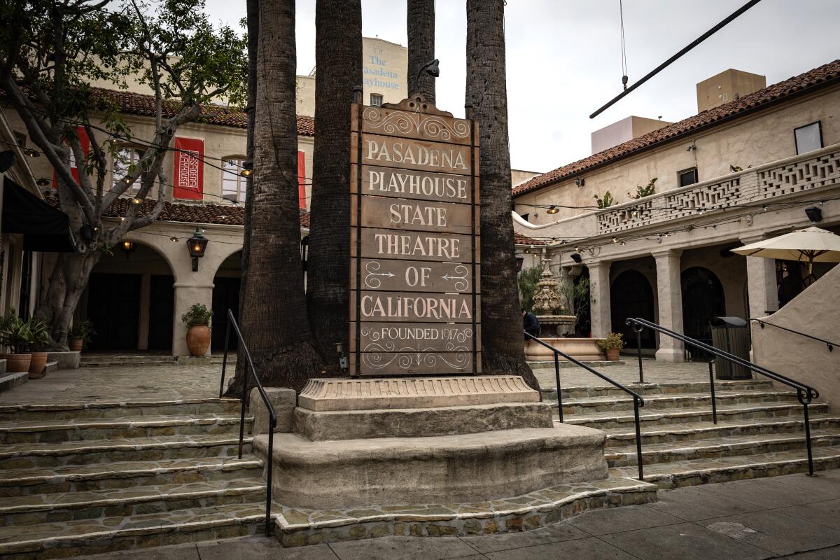 A sign in a courtyard reads "Pasadena Playhouse, State Theatre of California."