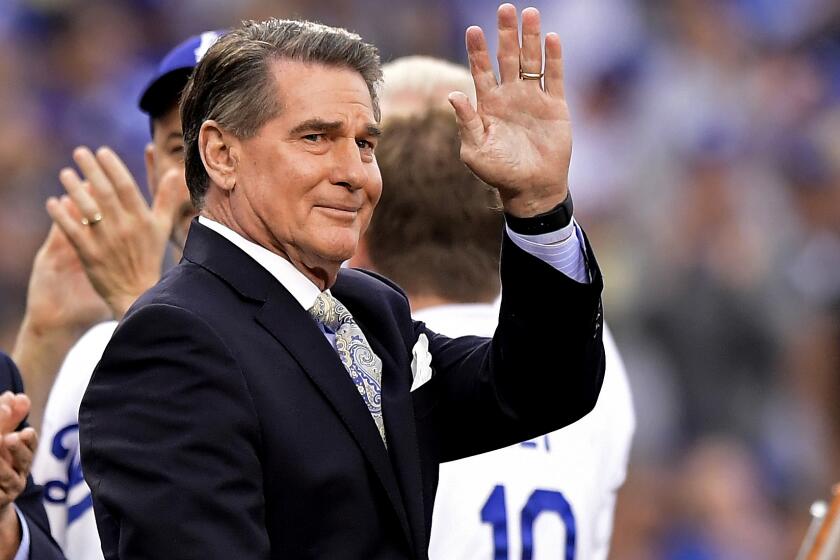 Former Dodger Steve Garvey waves to fans prior to a baseball game on Saturday, June 1, 2019, in Los Angeles.