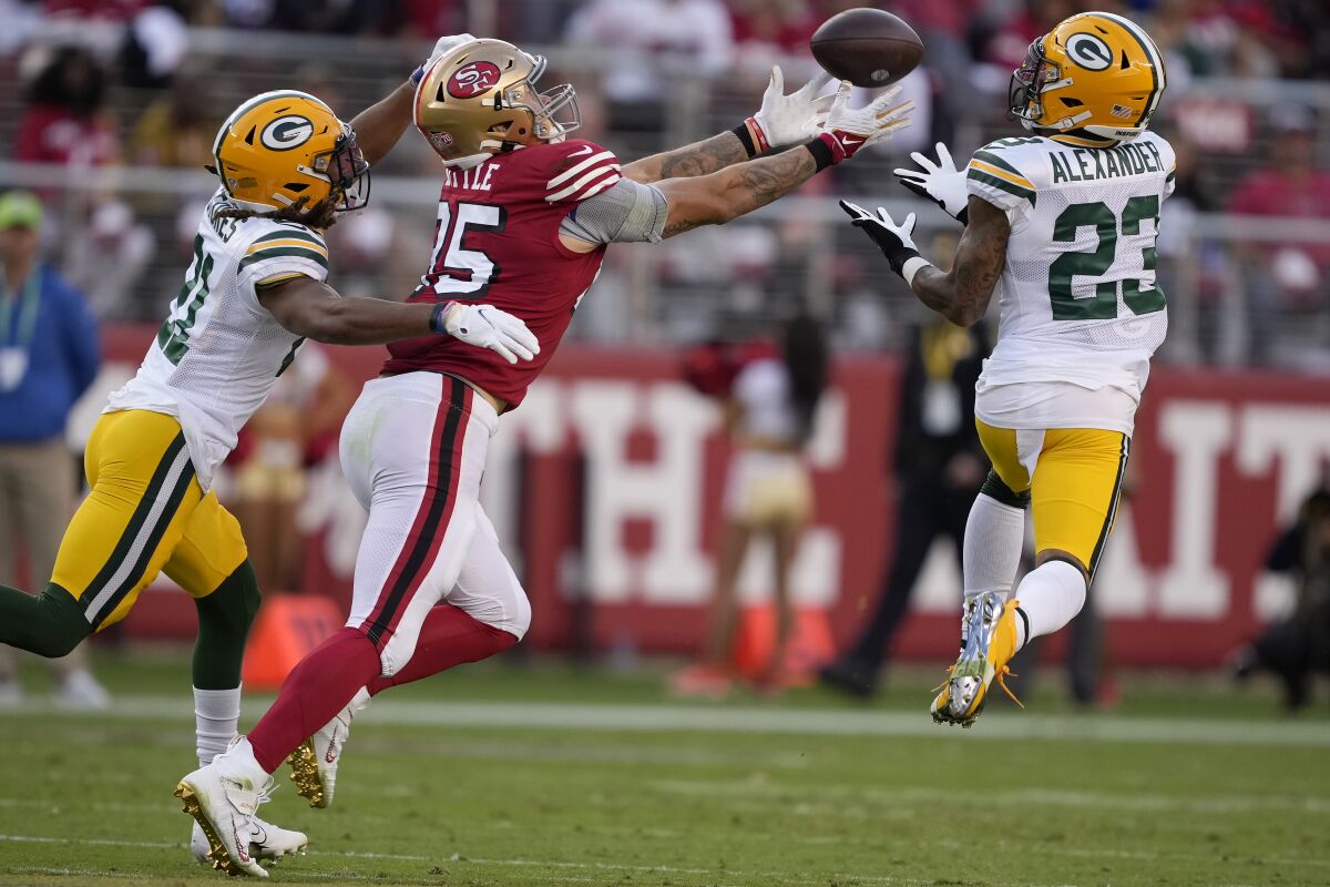Green Bay Packers cornerback Jaire Alexander (23) intercepts a pass intended for San Francisco 49ers tight end George Kittle, middle, during the first half of an NFL football game in Santa Clara, Calif., Sunday, Sept. 26, 2021. (AP Photo/Tony Avelar)