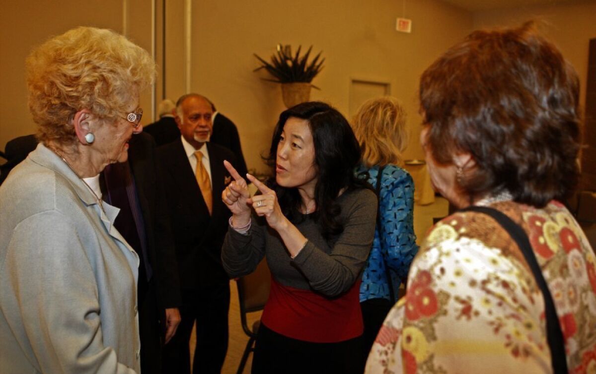 Michelle Rhee, center, answers questions after delivering a speech to the World Affairs Council in Los Angeles.