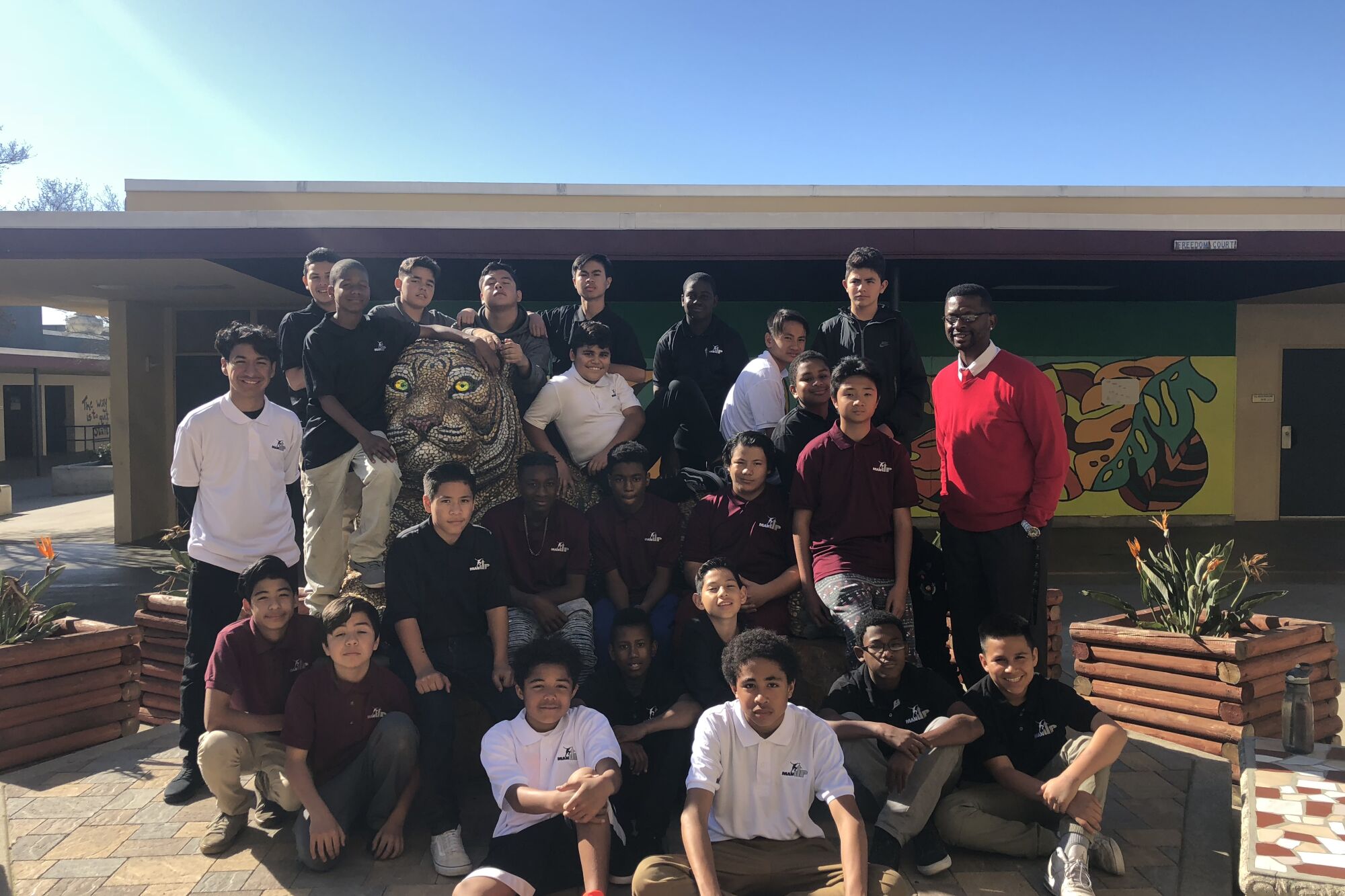 Roosevelt Johnson, top right, stands with students in Wilson Middle School's Man Up program.