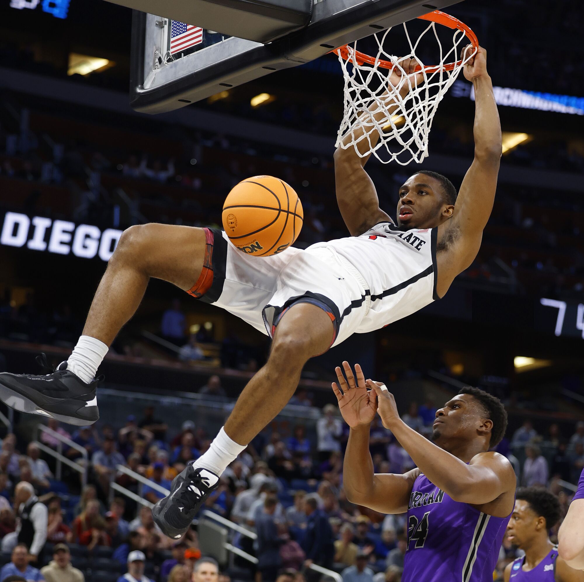 Lamont Butler dunks over Furman's Alex Williams on Saturday during the second round of the NCAA Tournament in Orlando, Fla.