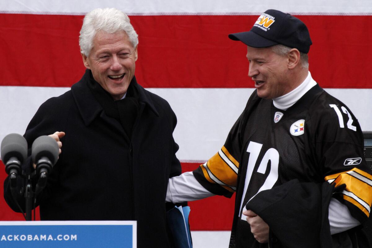 Rep. Mark Critz (D-Pa.), sporting a Terry Bradshaw Steelers jersey, introduces former President Clinton at a rally to get out the vote for President Obama in downtown Pittsburgh.