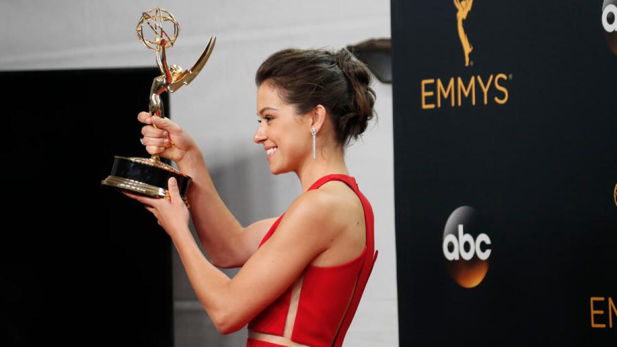 Tatiana Maslany holds up her Emmy Award for lead actress in a drama series.